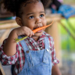 child-eating-baby-carrot-2023-11-27-05-35-11-utc